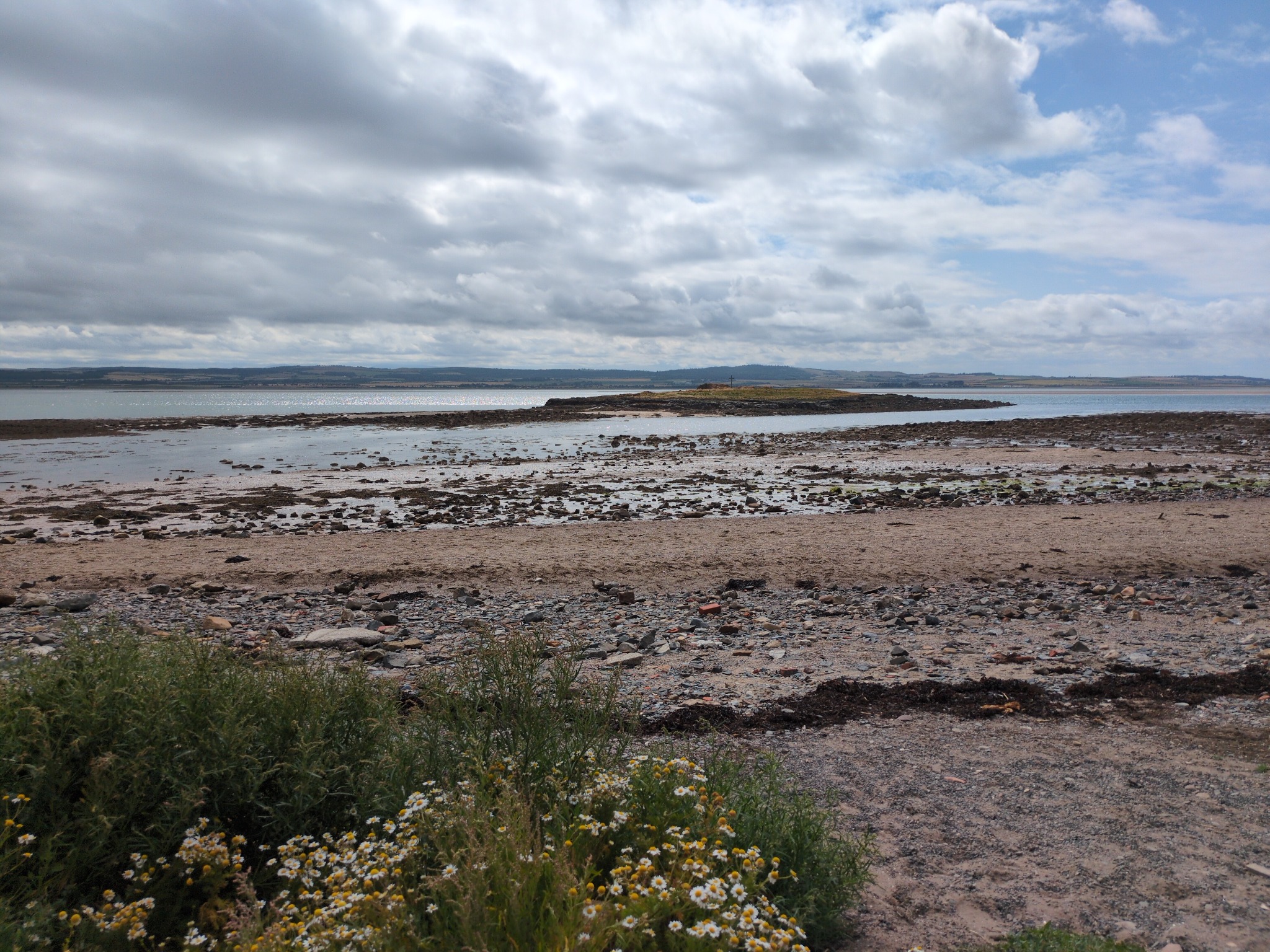 The shore at Lindisfarne beneath a wide sky